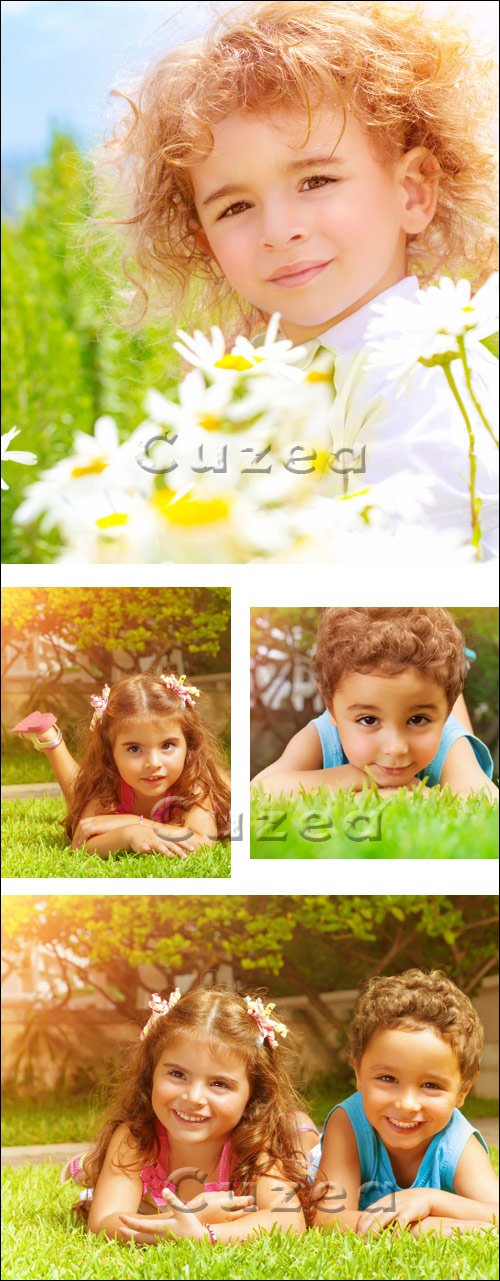      / Happy kids on green grass - stock photo