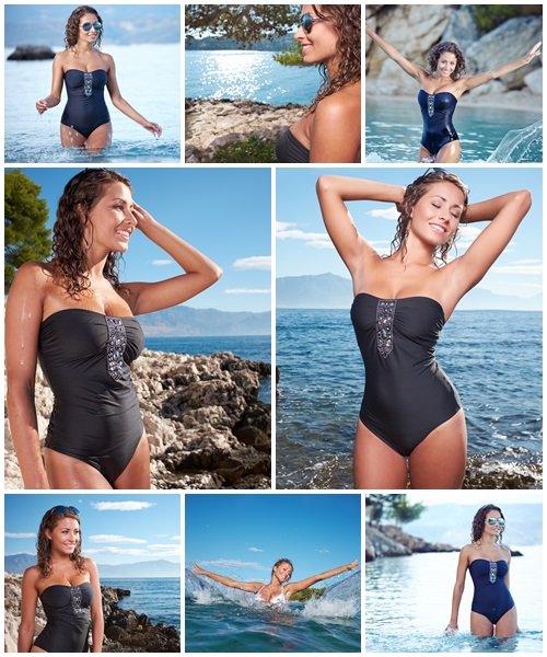 Beautiful young woman in bikini on the beach splashing water - Stock Photo